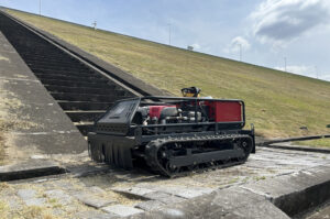 remote controlled lawn mower on dams